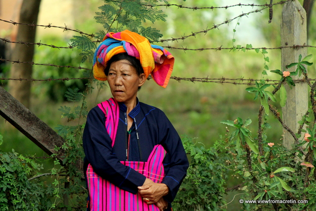 A lady watches a monk's funeral procession at Inle Lake in Myanmar.