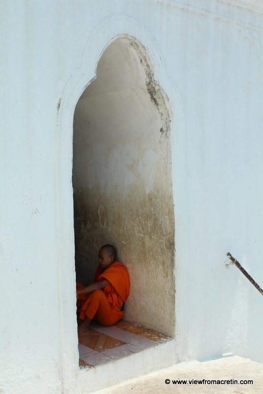 A monk rests in an alcove at Hsinbyume Paya, Mingun.