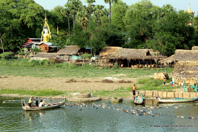 A bustle of activity at sunset in Taungthaman village on the other side of U Bein's Bridge as families return home from the day's work.